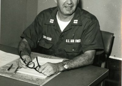 Air Force Capt. T. Raymond Sullivan sits at a desk